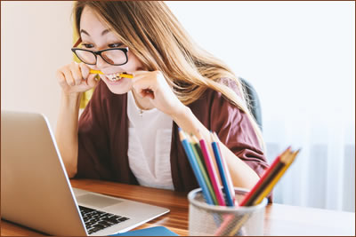 Woman chewing pencil